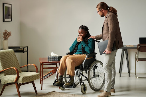 therapist comforts patient in wheelchair